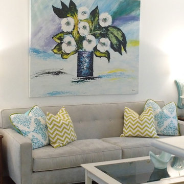 Living room with turquoise linen draperies, pearl gray sofa, citrus and white.