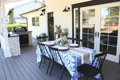 Outdoor kitchen deck - large farmhouse backyard outdoor kitchen deck idea in Seattle with a roof extension