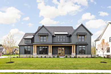 Inspiration for a large transitional black two-story concrete fiberboard exterior home remodel in Columbus with a shingle roof and a black roof
