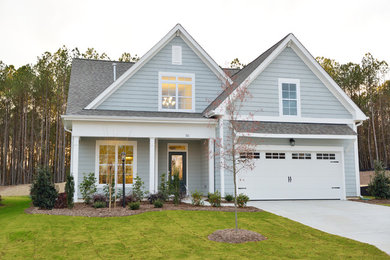Example of a classic gray two-story exterior home design in Raleigh