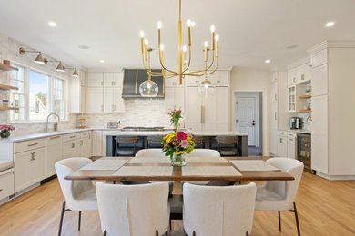 Inspiration for a large transitional light wood floor and brown floor kitchen/dining room combo remodel in Boston with white walls