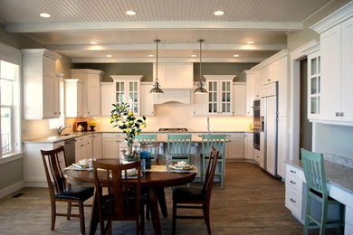 Large medium tone wood floor eat-in kitchen photo in Salt Lake City with white cabinets, stainless steel appliances and an island