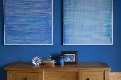 This is an example of a medium sized contemporary open plan dining room in Cardiff with blue walls.