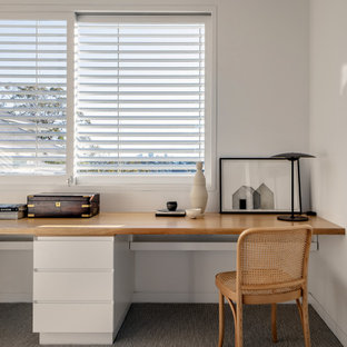 Design ideas for a contemporary home office in Sydney with white walls, carpet and a built-in desk.