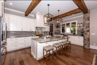 Inspiration for a cottage kitchen remodel in Other with gray backsplash, ceramic backsplash, stainless steel appliances, an island and multicolored countertops