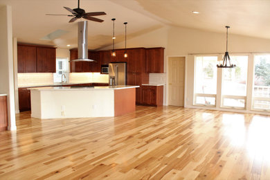 Eat-in kitchen - light wood floor eat-in kitchen idea in Other with an undermount sink, shaker cabinets, white backsplash and an island
