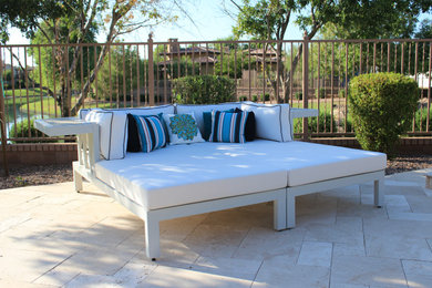 Design ideas for a large transitional backyard patio in Phoenix with natural stone pavers and no cover.