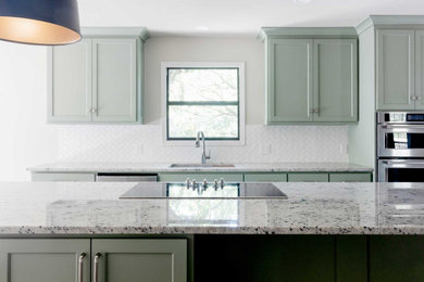 Inspiration for a galley eat-in kitchen remodel in Other with an undermount sink, shaker cabinets, green cabinets, granite countertops, white backsplash, subway tile backsplash, stainless steel appliances, an island and gray countertops