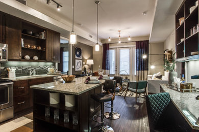 Inspiration for a large timeless galley dark wood floor and brown floor enclosed kitchen remodel in Houston with an undermount sink, recessed-panel cabinets, dark wood cabinets, granite countertops, green backsplash, ceramic backsplash, stainless steel appliances and an island