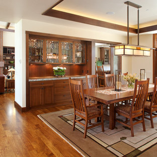Photo of a mid-sized arts and crafts open plan dining in San Diego with white walls, medium hardwood floors and no fireplace.