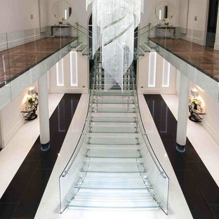Design ideas for an expansive contemporary glass floating glass railing staircase in Other with glass risers.