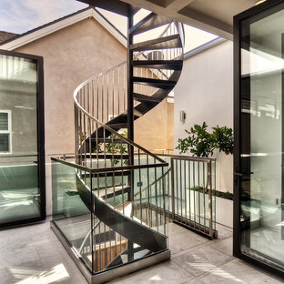 Inspiration for a medium sized contemporary spiral metal railing staircase in Orange County with slate treads and open risers.