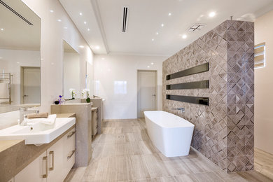Photo of a large contemporary master bathroom in Perth with flat-panel cabinets, beige cabinets, a freestanding tub, a double shower, a two-piece toilet, beige tile, travertine, beige walls, travertine floors, an integrated sink, engineered quartz benchtops, beige floor, an open shower, beige benchtops, a double vanity and a built-in vanity.