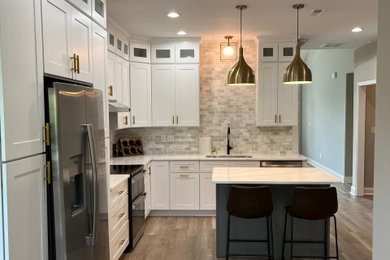 Kitchen pantry - mid-sized traditional l-shaped light wood floor and brown floor kitchen pantry idea in Louisville with an undermount sink, shaker cabinets, white cabinets, quartz countertops, gray backsplash, ceramic backsplash, stainless steel appliances, an island and white countertops