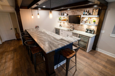 Photo of a traditional galley wet bar in Grand Rapids with shaker cabinets, white cabinets, granite worktops, brown splashback, ceramic splashback, vinyl flooring and brown floors.