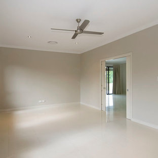 Home theater - contemporary porcelain floor home theater idea in Cairns with beige walls