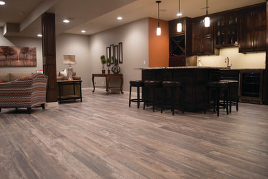 Large transitional open concept vinyl floor and gray floor family room photo in Other with a bar, gray walls, no fireplace and no tv