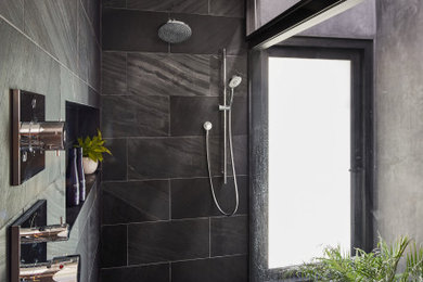 Design ideas for a large midcentury master wet room bathroom in Los Angeles with furniture-like cabinets, brown cabinets, a freestanding tub, a one-piece toilet, black tile, slate, white walls, slate floors, an undermount sink, wood benchtops, brown floor, an open shower and brown benchtops.