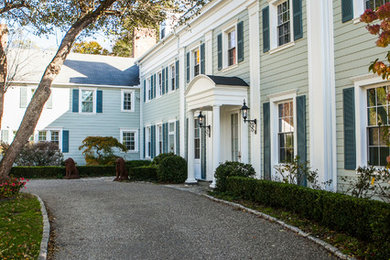 Large elegant white two-story vinyl exterior home photo in New York