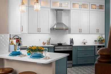 Inspiration for a transitional ceramic tile kitchen remodel in Austin with an undermount sink, shaker cabinets, white backsplash, porcelain backsplash, stainless steel appliances and white countertops