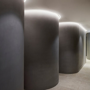 Curved microcement corridor with concealed lighting