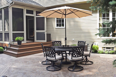 Modern backyard patio in Cleveland with stamped concrete and no cover.