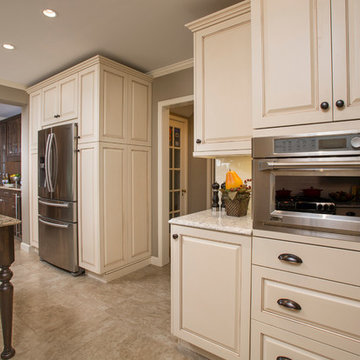 Custom Painted Maple Cabinetry accommodates the built-in appliances