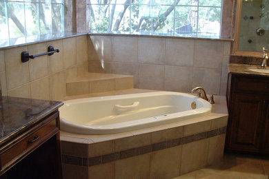 Example of a large transitional master beige tile and ceramic tile ceramic tile bathroom design in Dallas with raised-panel cabinets, dark wood cabinets, beige walls, an undermount sink and marble countertops