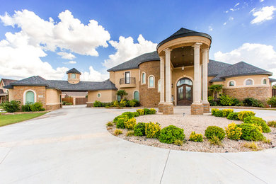 Large traditional beige two-story exterior home idea in Austin