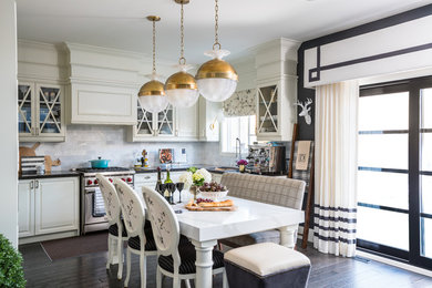 Example of a transitional l-shaped dark wood floor and brown floor eat-in kitchen design in Toronto with an undermount sink, white backsplash and stainless steel appliances