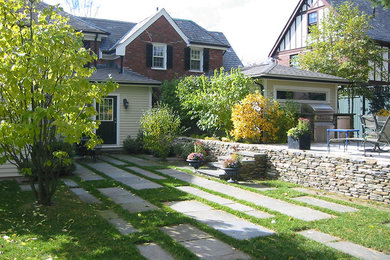 Inspiration for a mid-sized timeless backyard stone patio kitchen remodel in Boston with no cover