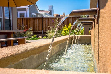 Patio fountain - mid-sized transitional backyard brick patio fountain idea in San Francisco with no cover