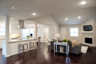 Inspiration for a mid-sized contemporary open concept dark wood floor family room remodel in Houston with gray walls, a corner fireplace, a brick fireplace and a wall-mounted tv