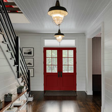 love this entry way with all ship lap stairs and red double doors