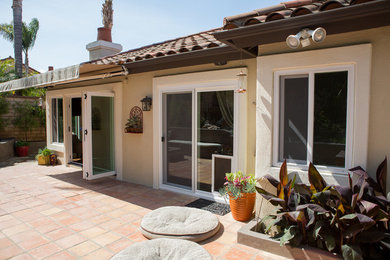 Mid-sized contemporary backyard patio in Orange County with tile and no cover.