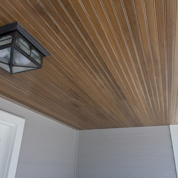 James Hardie Pearl Gray siding installation with wooden porch ceiling