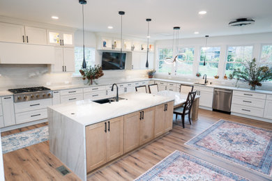 Inspiration for a large transitional u-shaped medium tone wood floor and brown floor eat-in kitchen remodel in Nashville with an undermount sink, shaker cabinets, medium tone wood cabinets, quartzite countertops, multicolored backsplash, stone slab backsplash, stainless steel appliances, an island and multicolored countertops