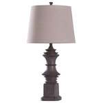 Stylecraft - Finn, Baluster Table Lamp, Dark Wood Grain Finish With Tapered Drum Tan Shade - A rustic table lamp that brings natural influence to living rooms, dining rooms and foyers. The skillfully designed polyresin frame features a dark wood grain finish, giving this traditional lamp a large dose of naturalism. The tan shade consists of linen and polyester, offering a nice complement to the table lamp�s strong frame and emphasizing the fixture�s farmhouse design.