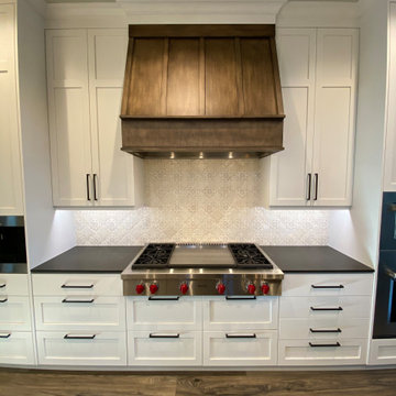 The Custom Rustic Hood Provides Contrast with Clean White Cabinets