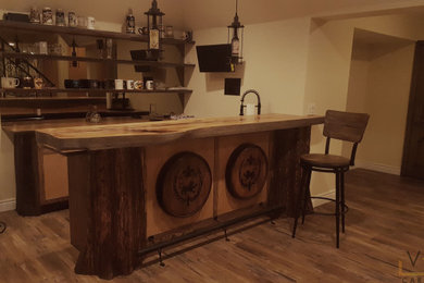 Example of a large mountain style galley wet bar design in New York with a drop-in sink, recessed-panel cabinets, dark wood cabinets and wood countertops