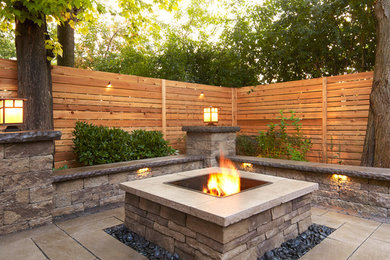Example of a large trendy backyard stamped concrete patio design in Boston with a fire pit and no cover
