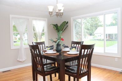 Inspiration for a mid-sized modern medium tone wood floor great room remodel in New York with gray walls
