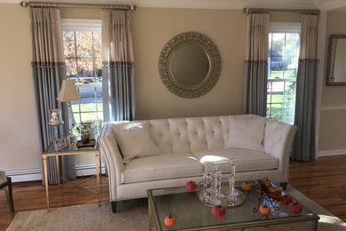 Example of a large classic formal and enclosed light wood floor living room design in New York with beige walls, no fireplace and no tv