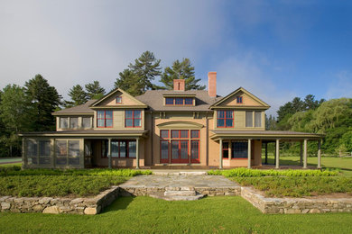 Large traditional brown two-story wood gable roof idea in Burlington