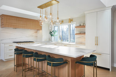 Inspiration for a large contemporary l-shaped light wood floor eat-in kitchen remodel in Grand Rapids with an undermount sink, shaker cabinets, light wood cabinets, white backsplash, porcelain backsplash, paneled appliances, an island and white countertops