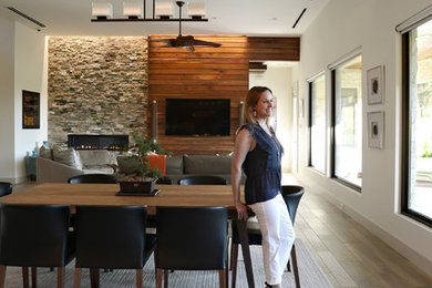 Inspiration for a mid-sized modern open concept medium tone wood floor and gray floor living room remodel in Dallas with white walls, a standard fireplace, a stone fireplace and a media wall