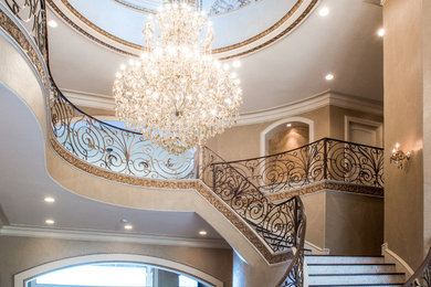 Inspiration for a large traditional foyer in Houston with beige walls and travertine floors.