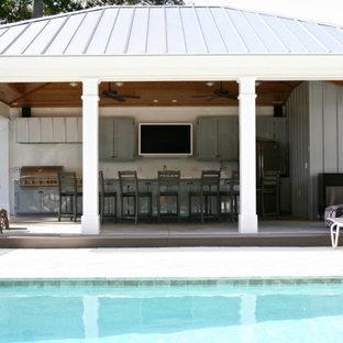 Large transitional backyard patio in Austin with an outdoor kitchen, concrete slab and a gazebo/cabana.