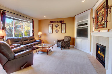Example of a mid-sized classic enclosed carpeted and beige floor living room design in Sacramento with beige walls, a standard fireplace, a tile fireplace and a media wall