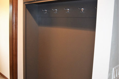 Mid-sized medium tone wood floor and brown floor hallway photo in Other
